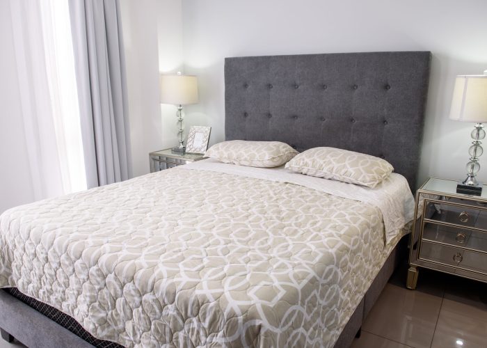 A beautiful view of a modern bedroom in white colors